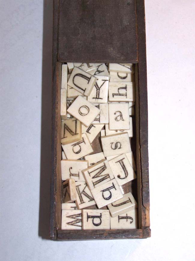 A Boxed set of 19th century Ivory or Bone Alphabets, 63 pieces, circa 1840